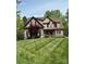 Charming stone home featuring a manicured lawn and complemented by lush landscaping at 394 Stonecliff Ln, Clover, SC 29710