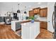 Well-lit kitchen with a center island, stainless steel appliances, and seamless dining area access at 394 Stonecliff Ln, Clover, SC 29710