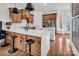 Bright kitchen with wooden accents, an island with seating, and high-end stainless steel appliances at 394 Stonecliff Ln, Clover, SC 29710