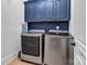 Laundry room featuring side-by-side washer and dryer with upper cabinets at 394 Stonecliff Ln, Clover, SC 29710