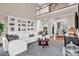 Bright, airy living room with tall ceilings, built-in shelving, and hardwood floors at 394 Stonecliff Ln, Clover, SC 29710