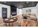 An open floor plan with a mounted TV, black ceiling, and hardwood style floors at 394 Stonecliff Ln, Clover, SC 29710