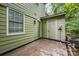 Backyard shed with door, concrete patio, and dense trees at 3941 Briarhill Dr, Charlotte, NC 28215