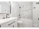 Modern renovated bathroom with a shower and tub featuring black hardware at 3941 Briarhill Dr, Charlotte, NC 28215