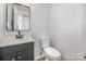 Modern half-bathroom with a sleek vanity, new fixtures, and a contemporary design at 3941 Briarhill Dr, Charlotte, NC 28215