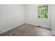 Bedroom with new carpet, white walls, base trim and view to outside trees at 3941 Briarhill Dr, Charlotte, NC 28215