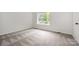 Bedroom with new carpet, white walls, base trim and view to outside trees at 3941 Briarhill Dr, Charlotte, NC 28215