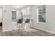 Bright kitchen featuring a breakfast bar, white cabinets, and stainless steel appliances for modern living at 3941 Briarhill Dr, Charlotte, NC 28215