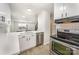 Well-lit kitchen with quartz countertops, stainless steel appliances, and white cabinetry for a clean design at 3941 Briarhill Dr, Charlotte, NC 28215