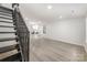 Open-concept space with staircase, kitchen access, light floors, and natural light enhancing the modern aesthetic at 3941 Briarhill Dr, Charlotte, NC 28215