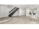 Spacious open-concept area flows from living space to kitchen with new floors, modern staircase and freshly painted walls at 3941 Briarhill Dr, Charlotte, NC 28215