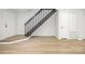 Inviting living space with new flooring, freshly painted walls, and a staircase leading upstairs at 3941 Briarhill Dr, Charlotte, NC 28215