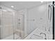 Bathroom showcasing double sinks, quartz countertop, shower with glass door and tile surround at 4008 Yucca Aly, Charlotte, NC 28217