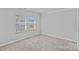 Bright bedroom featuring neutral carpeting, crown molding, and natural light from two windows at 4008 Yucca Aly, Charlotte, NC 28217