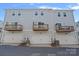 Townhouse rear view featuring private decks above individual garage spaces at 4008 Yucca Aly, Charlotte, NC 28217
