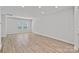 Open-concept living space with hardwood floors and large windows providing ample light at 4008 Yucca Aly, Charlotte, NC 28217
