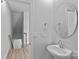 Cozy powder room featuring a round mirror, pedestal sink, and modern fixtures at 4008 Yucca Aly, Charlotte, NC 28217