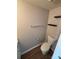 Toilet and towel rack in neutral bathroom with wooden floor at 4151 Town Center Rd, Harrisburg, NC 28075