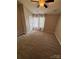 Cozy bedroom features a ceiling fan, neutral carpet, and plenty of natural light at 4151 Town Center Rd, Harrisburg, NC 28075