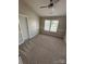 Bedroom featuring fresh paint, new carpet, and natural light at 4151 Town Center Rd, Harrisburg, NC 28075