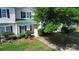 Charming townhome featuring a well-manicured lawn and tasteful landscaping, complete with a welcoming front walkway at 4151 Town Center Rd, Harrisburg, NC 28075