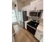 Contemporary kitchen featuring stainless steel appliances, white cabinets, and ample counter space at 4151 Town Center Rd, Harrisburg, NC 28075