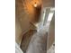 Carpeted staircase with wooden railing leads to the upper level, illuminated by a decorative light fixture at 4151 Town Center Rd, Harrisburg, NC 28075