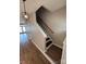 Open staircase with hardwood floors and handrail leads to the upper level of the home at 4151 Town Center Rd, Harrisburg, NC 28075
