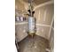 A small utility room features a hot water heater and storage shelves at 4151 Town Center Rd, Harrisburg, NC 28075