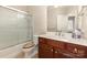 Bathroom featuring cherry wood cabinets, vanity, commode, and a shower and tub with sliding glass doors at 4208 Rosy Billed Ct # 30, Fort Mill, SC 29707