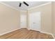 Empty bedroom featuring hardwood floors and white doors with plenty of natural light from the window at 4208 Rosy Billed Ct # 30, Fort Mill, SC 29707