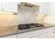 Close-up of the gourmet kitchen features gas cooktop and stylish backsplash at 4208 Rosy Billed Ct # 30, Fort Mill, SC 29707