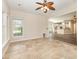 Bright living room with tile flooring, ceiling fan, and a view into the kitchen area at 4208 Rosy Billed Ct # 30, Fort Mill, SC 29707