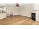 Inviting living room featuring a fireplace, archway, ceiling fan, and wood floors at 4208 Rosy Billed Ct # 30, Fort Mill, SC 29707