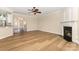 Bright living room features a fireplace, hardwood floors, and ceiling fan at 4208 Rosy Billed Ct # 30, Fort Mill, SC 29707