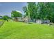View of a fenced backyard that features a playhouse, shed, and swing at 426 Valley St, Stanley, NC 28164