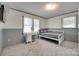This bedroom has two windows and is staged with a bed and makeup table at 426 Valley St, Stanley, NC 28164