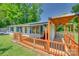 Inviting side porch with wood railing, covered seating area, and outdoor furniture at 426 Valley St, Stanley, NC 28164