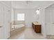 Bathroom features a soaking tub, spacious vanity, and natural lighting from window at 441 Vermilion Dr, York, SC 29745