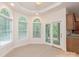 Bright breakfast nook with arched windows, tile floor, and access to a screened porch at 441 Vermilion Dr, York, SC 29745