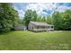 Charming house with a covered front porch, white railing, and a detached garage on a green lawn at 441 Vermilion Dr, York, SC 29745
