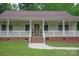 Charming covered porch with brick accents, white railings, and meticulously maintained landscaping at 441 Vermilion Dr, York, SC 29745