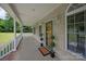 Inviting covered porch with a stylish entryway featuring a welcome mat and decorative topiaries at 441 Vermilion Dr, York, SC 29745
