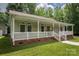 Welcoming covered porch featuring white railings, brick accents, and a beautifully maintained exterior at 441 Vermilion Dr, York, SC 29745
