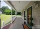 Charming covered porch with a stylish entryway featuring topiaries and a welcome mat at 441 Vermilion Dr, York, SC 29745