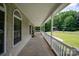 Wide front porch with white railings, arched windows, and ample space for outdoor seating at 441 Vermilion Dr, York, SC 29745