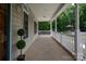 Spacious front porch featuring classic columns and wooded views perfect for relaxing outdoors at 441 Vermilion Dr, York, SC 29745
