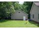 Attached garage with brick accents and siding, surrounded by greenery, and lush landscaping at 441 Vermilion Dr, York, SC 29745