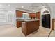 Kitchen features an island, wood cabinets, and modern appliances for cooking convenience at 441 Vermilion Dr, York, SC 29745