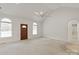 Airy living room with vaulted ceiling, arched windows, and access to other rooms in the home at 441 Vermilion Dr, York, SC 29745